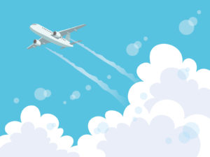 雲の向こうを飛ぶ飛行機